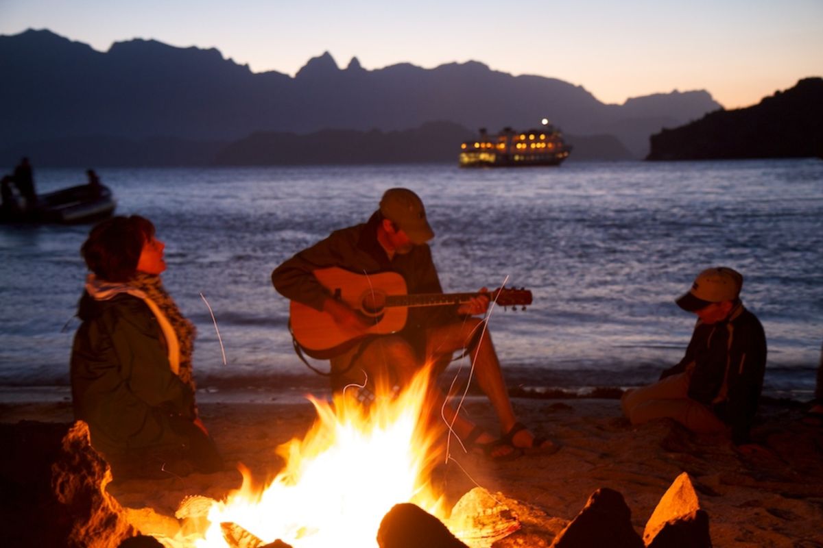 Campfire at seashore | Sales Motivation Secrets So Simple Even A Caveman Can Use Them