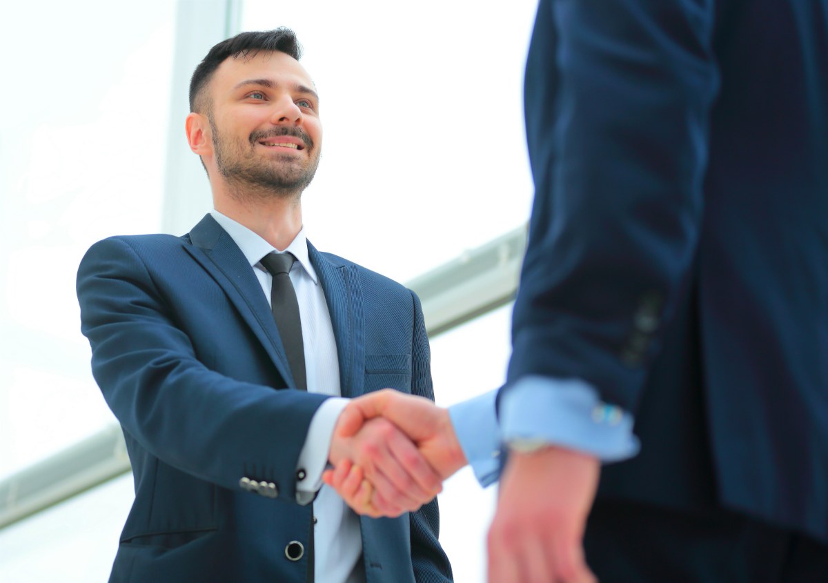 businessmen handshake | Unique Aspects of Inside Sales in EMEA w/Christian Obando @Tesla | inside sales team | building an inside sales team