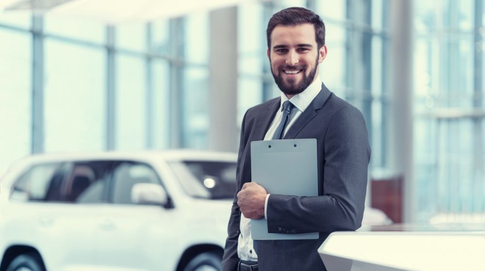 Smiling businessman with clipboard