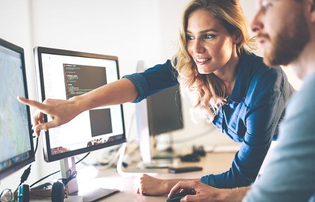 a business man and woman using computer, the wowan is pointing at the screen | Software