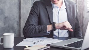 a business man checking his what at the working table