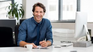 a business man sitting at the desk in the office