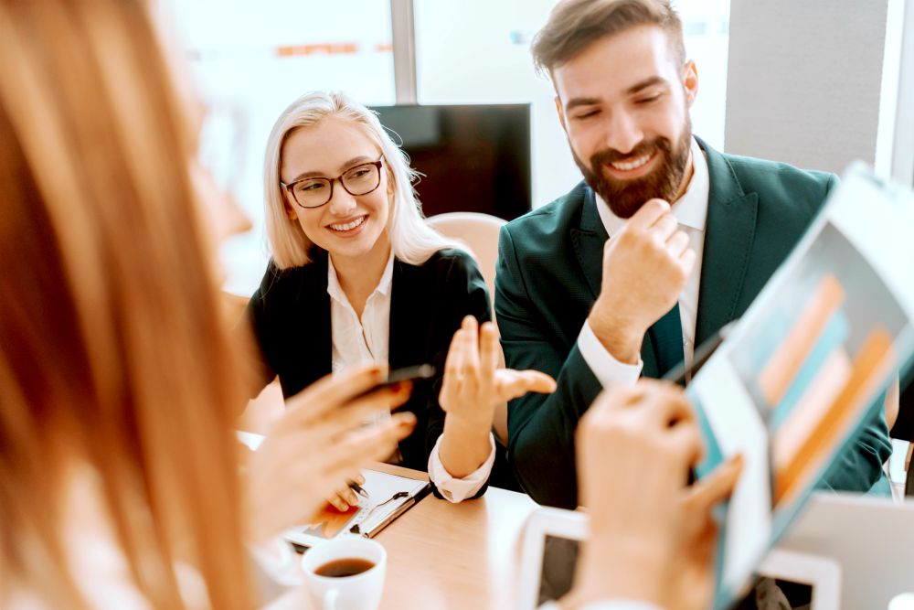 Attractive businessman and businesswoman looking at chart at meeting in boardroom | How SaaS Metrics Can Help You Drive Explosive Growth Like Salesforce | customer success | acv sales