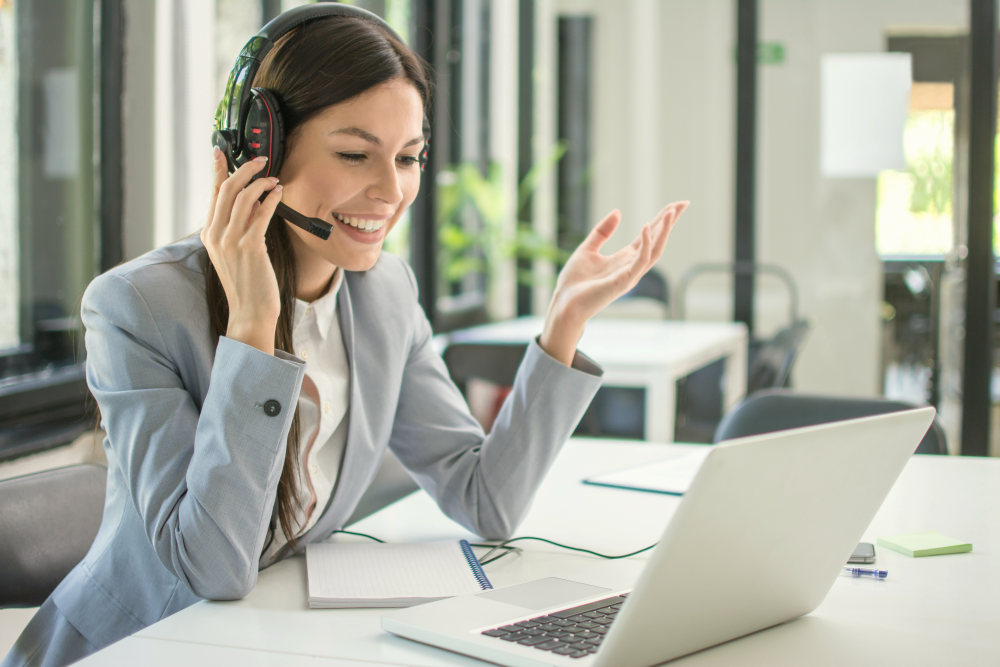 Beautiful young call center operator woman in headset talking to a client in office | Tips For An Effective Sales Follow Up | follow up sales email