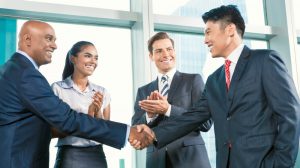 Business handshake in lofty office with city view