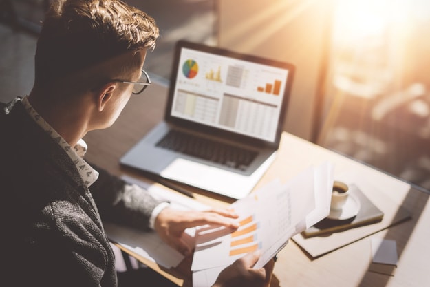 business man looking at graphics and diagrams on a computer | Check Targets are Fair | work from home