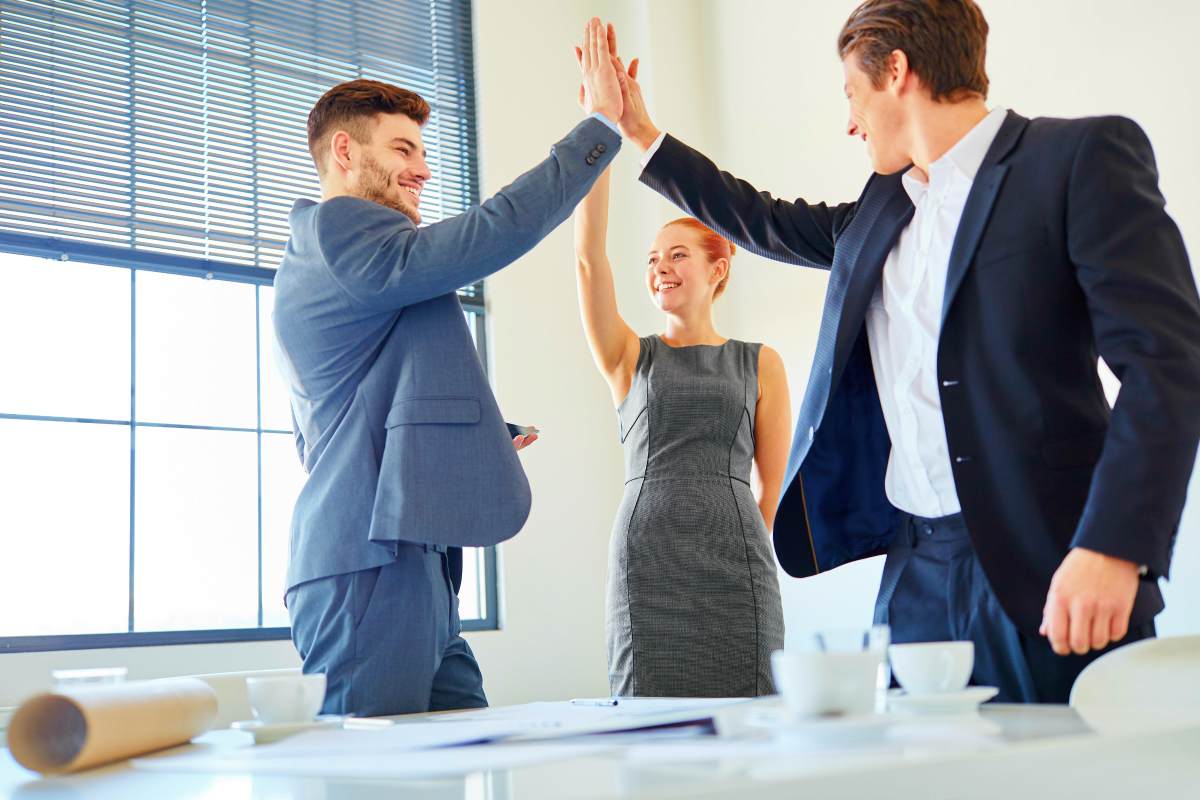 Successful team making high five | The Five Traits of Great Leaders