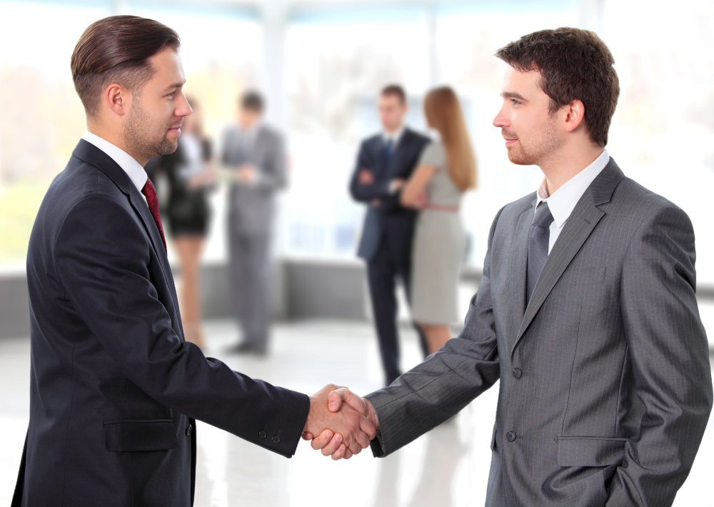 Business people shaking hands over a deal | Tips For Overcoming Sales Objections With Ease | common objections