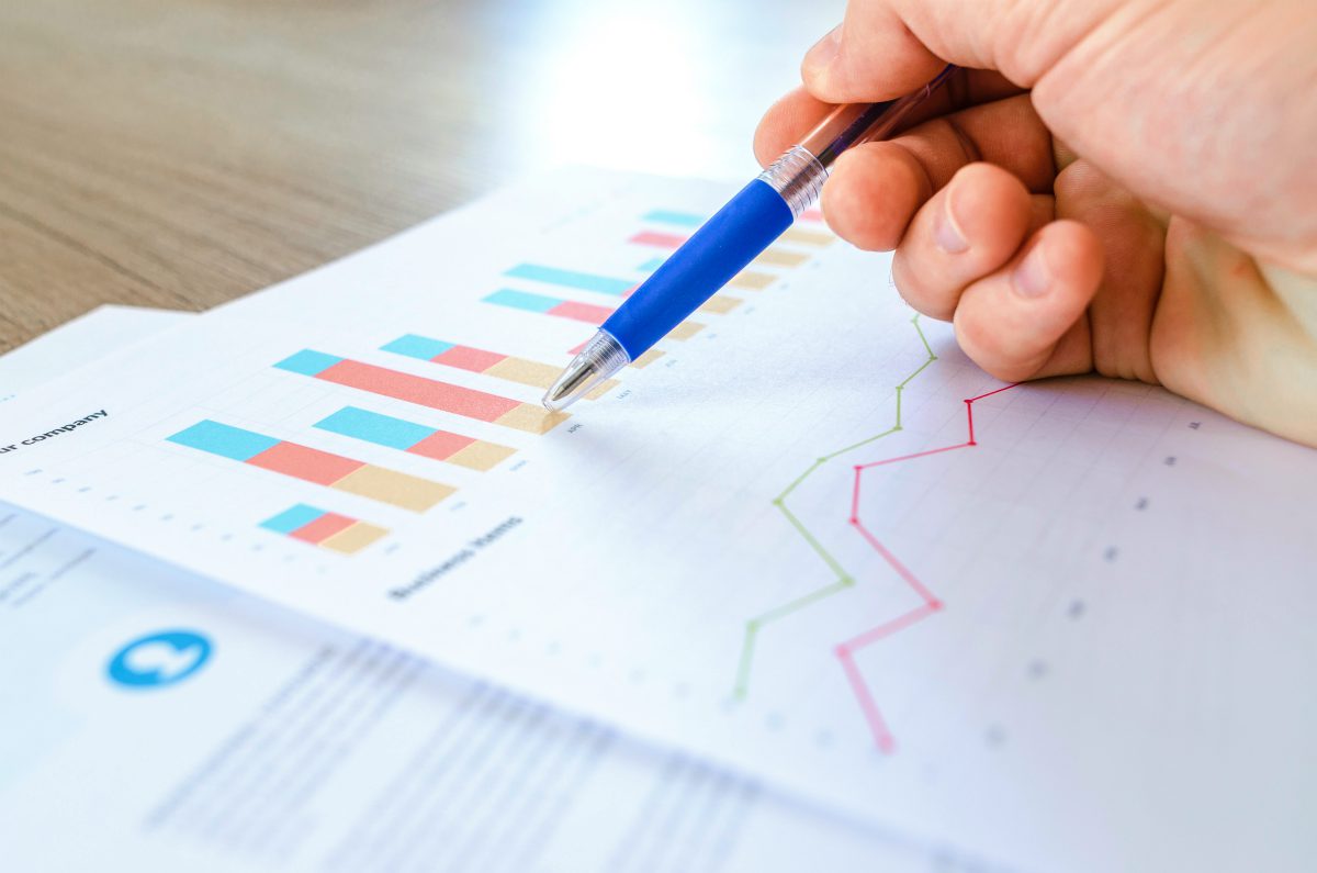 man pointing at a chart | Cross Selling And How It Can Drive Growth and Profitability To Your Business | cross-selling | what is cross-selling in retail