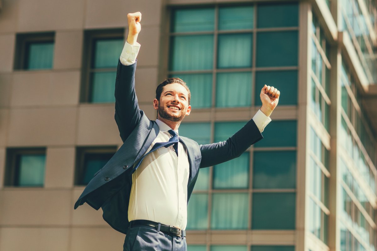 Cheerful businessman celebrating | How to Create a Winning Culture