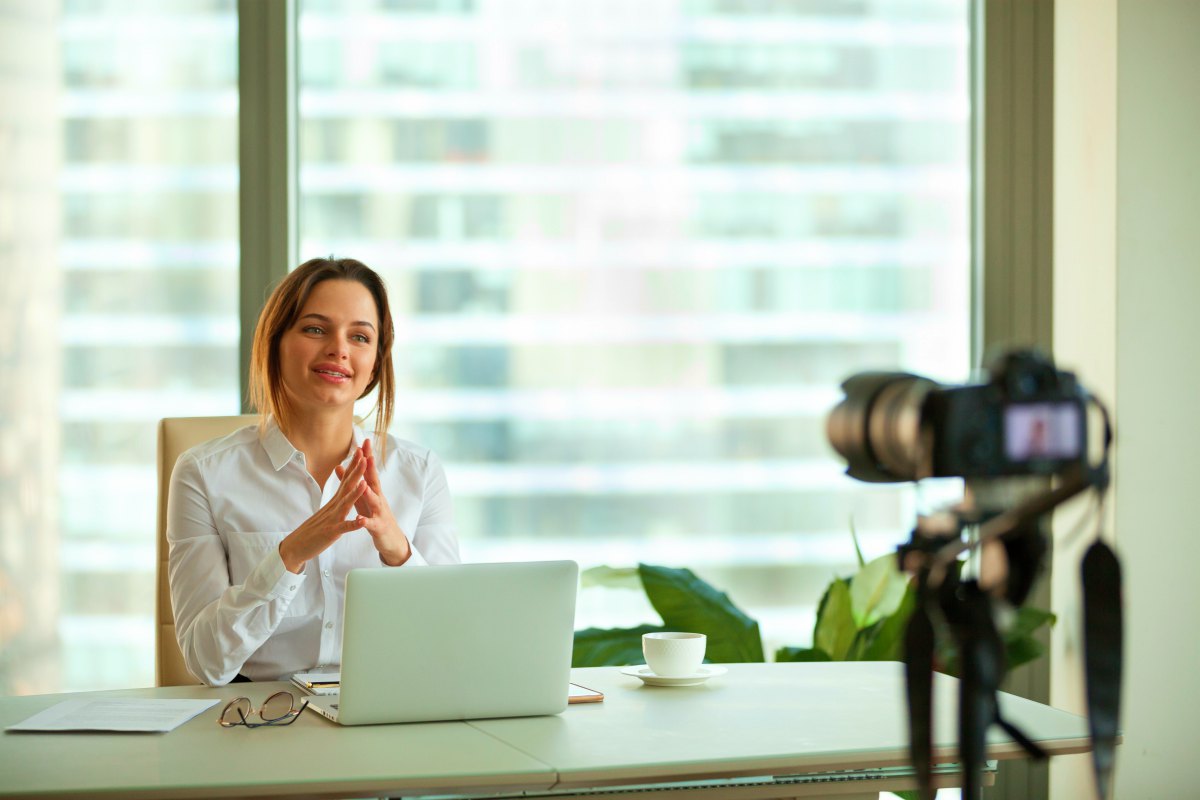 woman recording a video in office | Why You Should Have a Virtual Meeting to Build Pipeline | sales conference