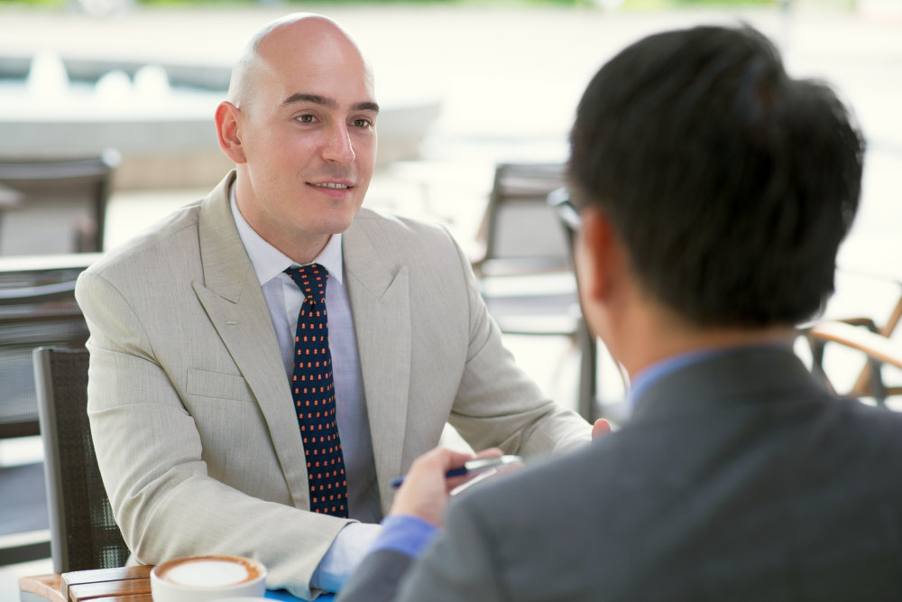 Man listening to another man talking | Tips To Create Effective B2B Sales Strategies | b2b | sales and marketing