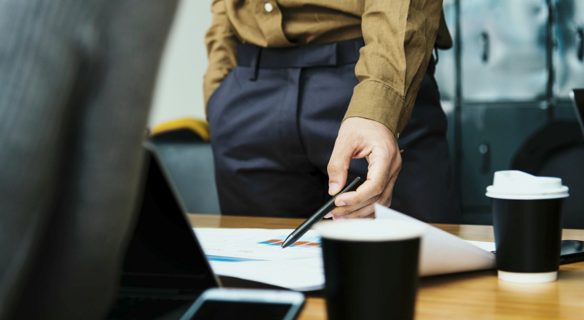 businessman pointing at documents | Definition of a Qualified Prospect and the Curse of the “Slow No” | prospect definition | prospect define