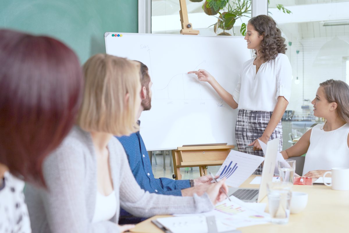 Colleague explaining infront the board room | Sales Effectiveness Metrics for Evaluating Your Team | sales effectiveness | sales performance metrics