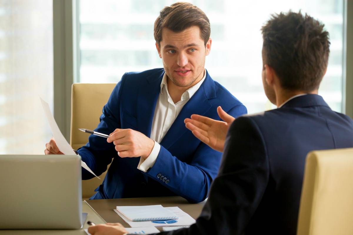 successful businessman clarifying provisions with his colleague | Cross Selling And How It Can Drive Growth and Profitability To Your Business | cross-selling | crossselling