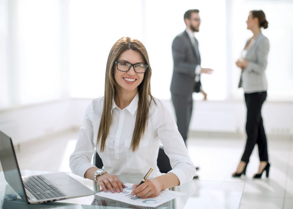 smiling woman at the office | Secrets to Successful Account Management with Suneal Rao at InsideSales.com | account management | account management planning