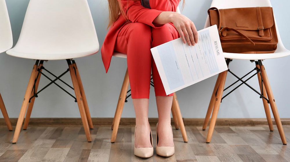 Woman wearing red waiting for interview | How To Become An Agile Inside Sales Rep | inside sales representative | how to become a sales rep